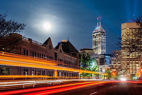Night view of high-rise buildings in Indianapolis metropolitan area with electric lighting