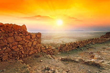 Sunrise over Israel horizon with orange afterglow on rock wall art