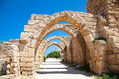 Ancient Jerusalem stone wall ruins, archaeological site and tourist attraction featuring an arch and arcade