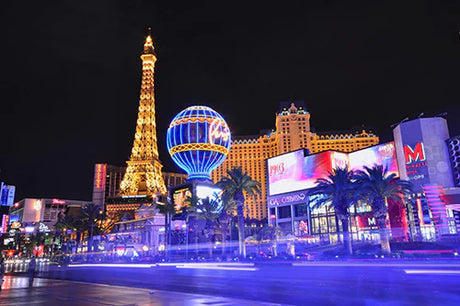 Nighttime Las Vegas skyline featuring illuminated skyscrapers and landmark towers