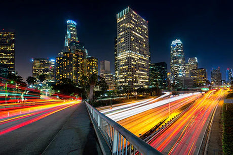 Night view of Los Angeles cityscape with lit skyscrapers and busy highways