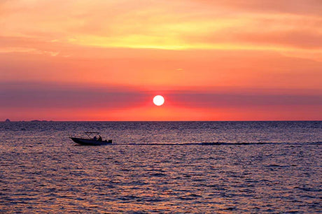 Madagascar collection wall art featuring sunset afterglow, boat silhouette, and orange dusk over water