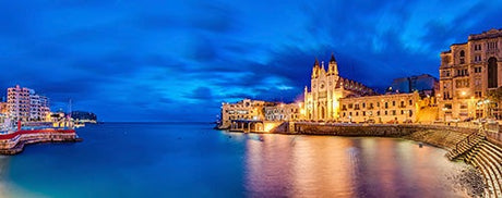 Night view of Malta's coastline cityscape with blue sea waters in the Malta Wall Art Collection