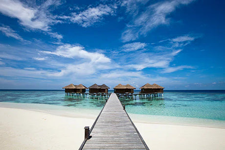 Blue water and summer beach view from a pier in the 'Martinique' wall art collection