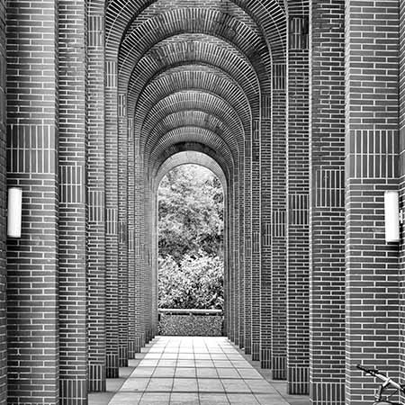 Black and white masonry wall art featuring a symmetrical brick archway corridor with geometric lines — Masonry wall art collection for architectural design lovers.