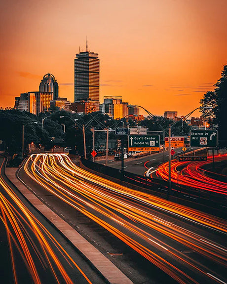 Dusk view of Massachusetts city skyline with skyscrapers, high-rise buildings, and roads