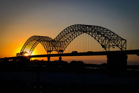 Memphis collection wall art featuring a dusk view of a tied-arch bridge under a cloudy evening sky