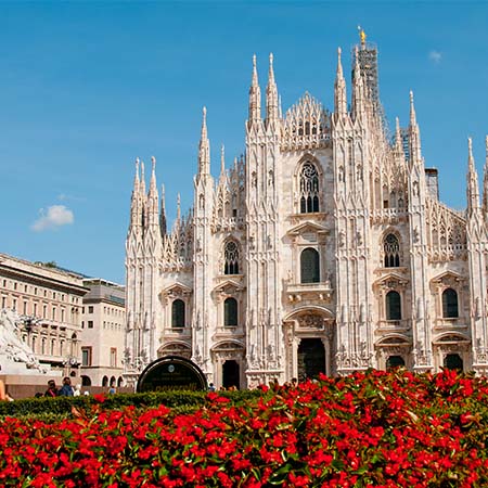 Milan Cathedral (Duomo di Milano) with blue sky and red flowers – elegant Italian architectural wall art for stylish home or office décor.