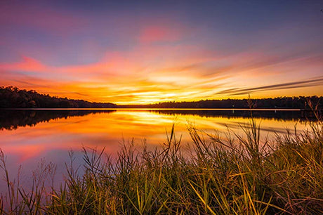 Mississippi collection wall art featuring a serene sunset over water with dusk clouds