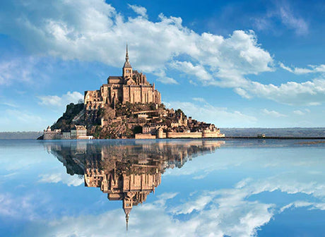Mont St. Michel water castle with spire reflection on ocean coast, popular tourist attraction