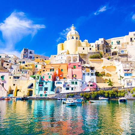 Colorful seaside buildings in Procida near Naples, Italy with vibrant reflections – coastal Mediterranean wall art for stylish home or office décor.