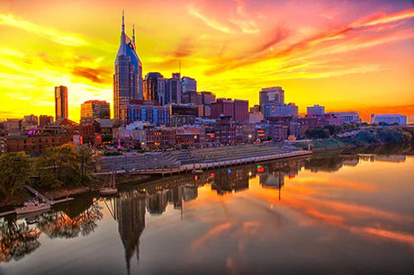 Nashville cityscape wall art featuring sunset over urban area with water, buildings, and tower