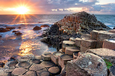 Sunset over the rocky coastline of Northern Ireland with ocean and afterglow view