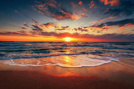 Stunning Oahu wall art featuring a vibrant orange sunset over a serene body of water at dusk
