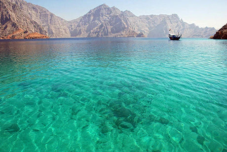 Coastal wall art featuring Oman's blue sea, mountainous headland, and serene lake view