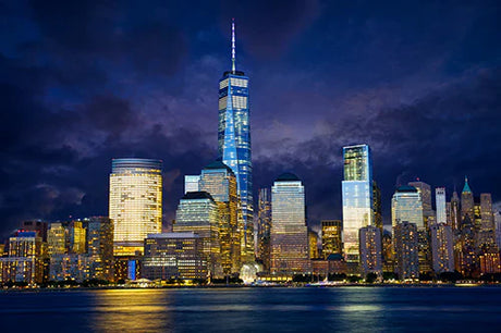 Blue daytime view of One World Trade Center skyscraper in urban metropolis