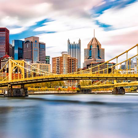 Colorful Pittsburgh skyline wall art featuring iconic yellow bridge and downtown skyscrapers under vibrant sky – perfect cityscape decor