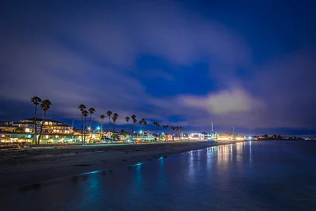 Santa Cruz collection wall art depicting a dusk-night beach view with street light reflections on the sea.