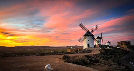 Spanish windmill wall art capturing a vibrant sunrise over a heat-kissed horizon at dusk.