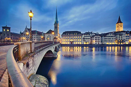Swiss cityscape wall art featuring a bridge, steeple, and waterway reflection