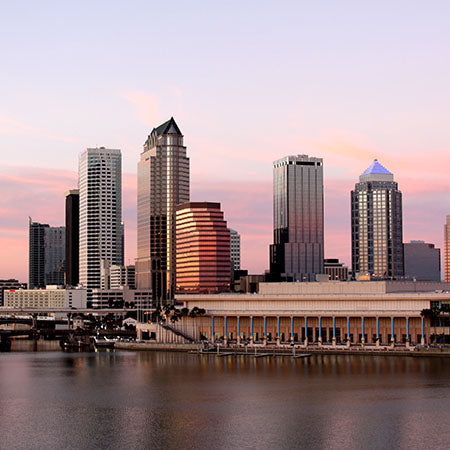 Tampa skyline at sunset with modern high-rises reflecting on the bay under a pastel sky – urban Florida wall art for contemporary home or office décor.