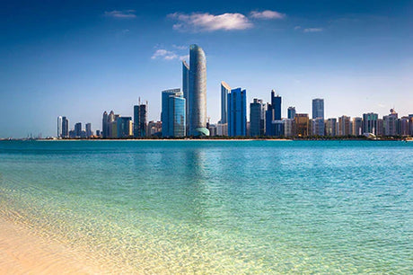 Daytime skyline of a metropolitan area in United Arab Emirates with high-rise buildings and blue sky.