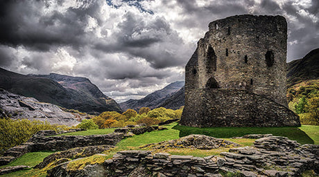 Scenic Welsh landscape with grassy highlands, rocky terrain, and cloud-shrouded mountain range wall art