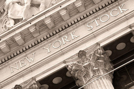 Classic Wall Street photograph featuring symmetrical Roman architecture, US flag, and intricate stone carvings
