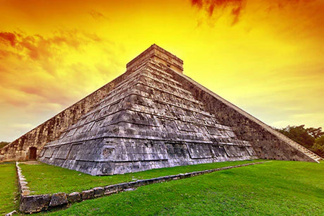 Sunlit Mayan pyramid in Yucatan, a World Heritage site with cumulus clouds