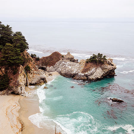 Summer wall art featuring a scenic coastal beach with turquoise waves, rocky cliffs, and soft sand — Summer wall art collection for coastal home decor.