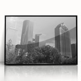 Large abstract wall art depicting geometric shapes in bold orange and black colors on canvas.