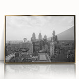 Large art print of a mid-century modernist cityscape in muted gray and blue tones on canvas.