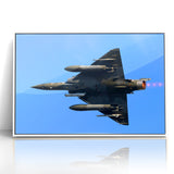 Modern Aviation Art: Fighter Jet in Flight Against Blue Sky Canvas Print