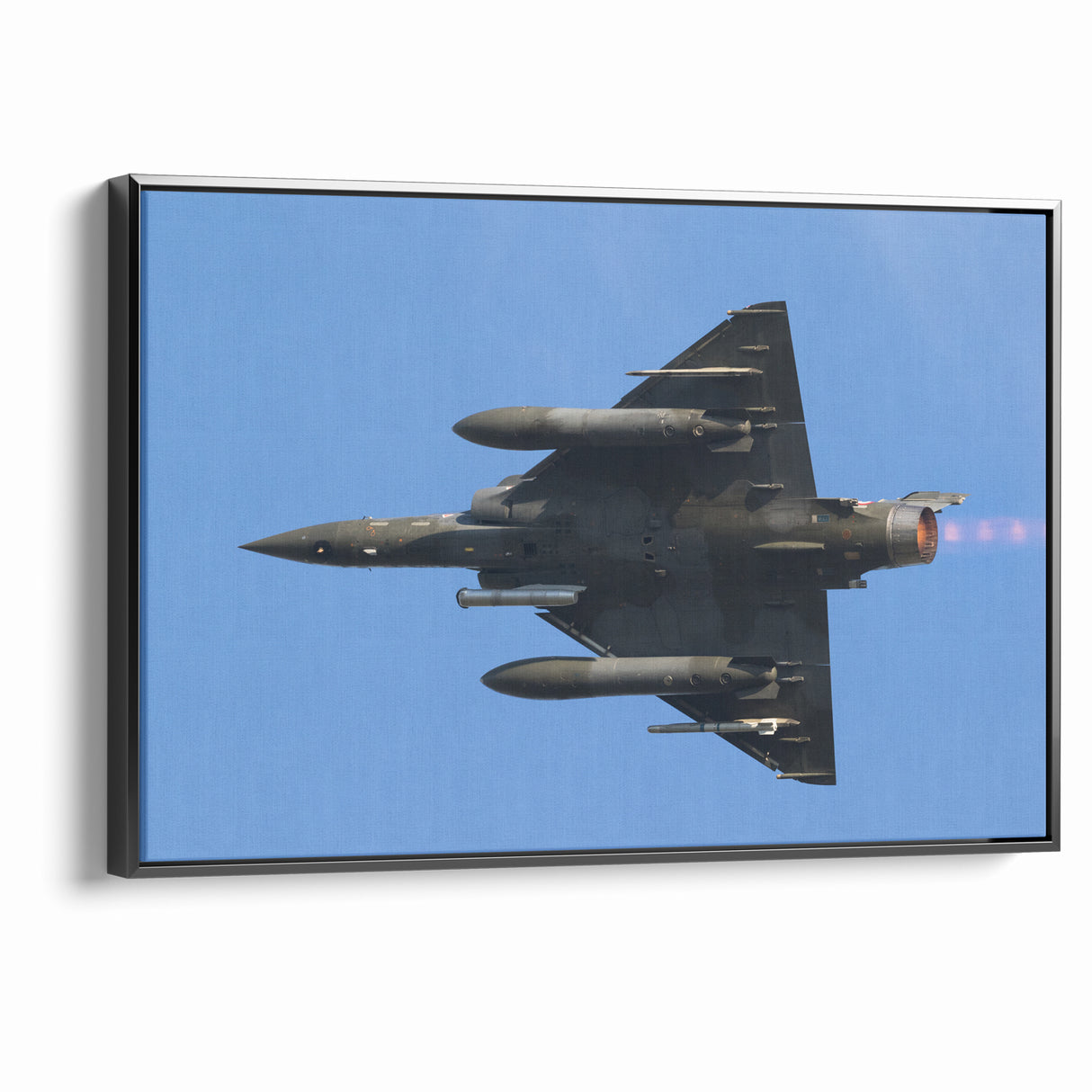 Modern Aviation Art: Fighter Jet in Flight Against Blue Sky Canvas Print