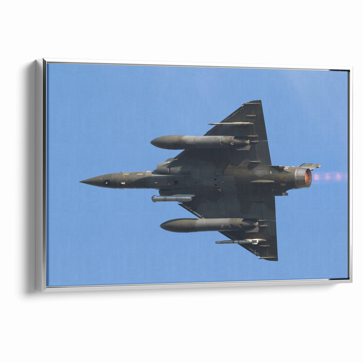 Modern Aviation Art: Fighter Jet in Flight Against Blue Sky Canvas Print