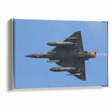 Modern Aviation Art: Fighter Jet in Flight Against Blue Sky Canvas Print