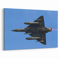 Modern Aviation Art: Fighter Jet in Flight Against Blue Sky Canvas Print