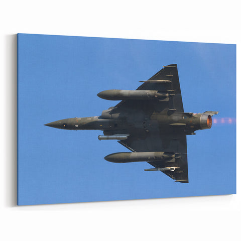 Modern Aviation Art: Fighter Jet in Flight Against Blue Sky Canvas Print