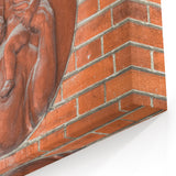 Masonry Wall Art - Religious Relief Sculpture on Brick Wall Canvas Print