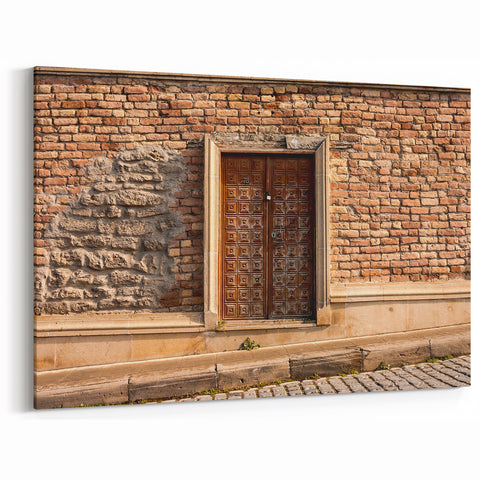 Masonry Wall Art - Ornate Wooden Door on Brick and Stone Wall Canvas Print