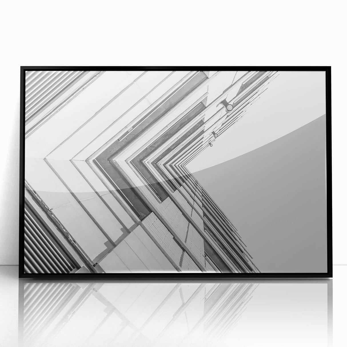Large abstract wall art featuring swirls of black and white on acrylic, framed, ideal for modern living room decor.