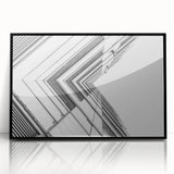 Large abstract wall art featuring swirls of black and white on acrylic, framed, ideal for modern living room decor.