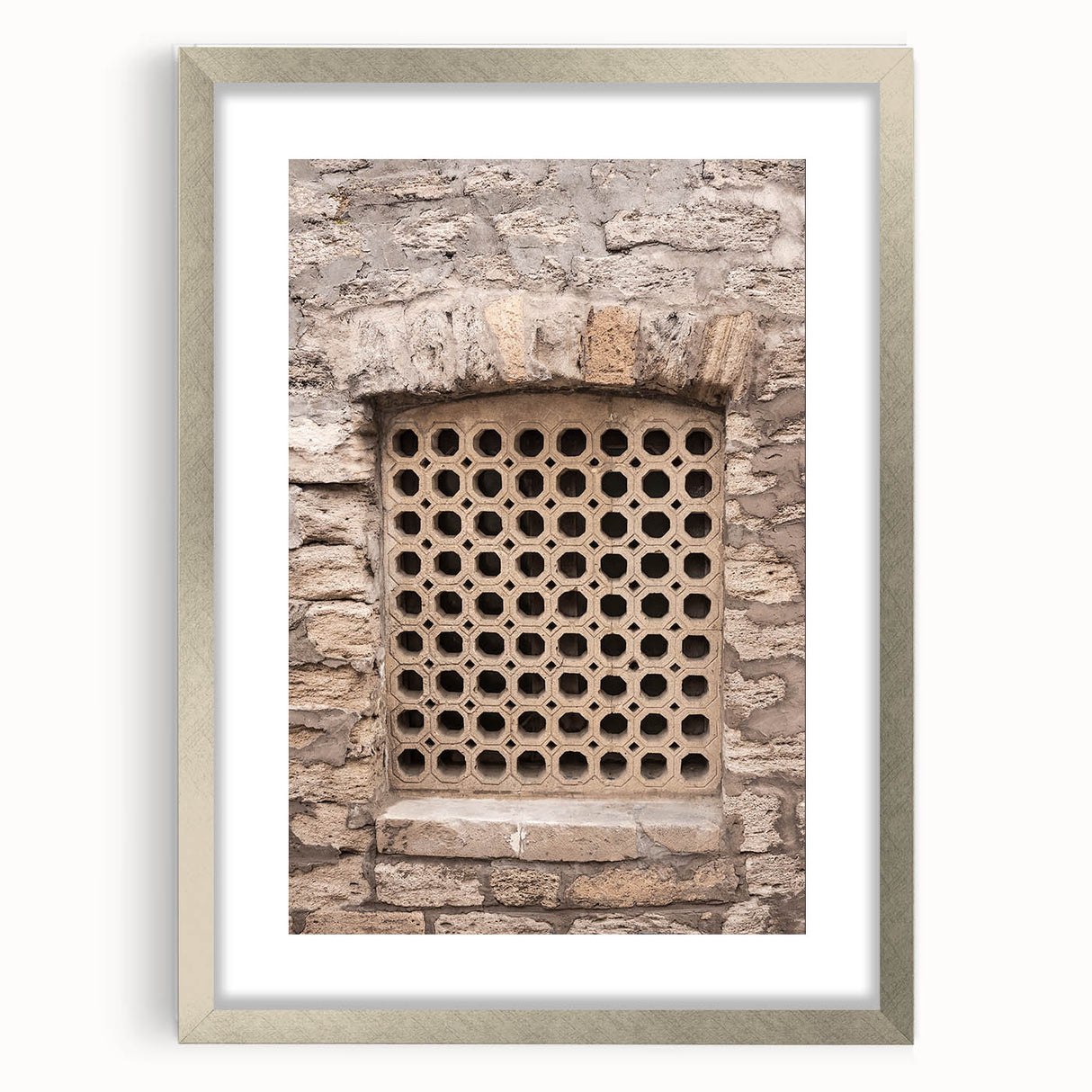 Textured abstract art print in gray and white, framed in silver, ideal for modern bedroom ambiance.