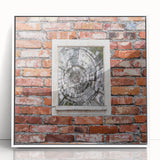 Art deco poster featuring geometric patterns in black and gold on a white acrylic framed print.