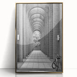 Large art print of geometric shapes in muted gold tones on acrylic, framed, in mid-century modernist style.