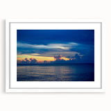 Abstract art print featuring swirling blue and white patterns on a framed canvas, suitable for dining room or bedroom decor.