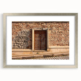 Textured abstract art print in muted gray and silver tones, displayed in a silver frame, suitable for bedroom decor.