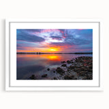 Abstract art print featuring swirling blue and grey patterns on a white framed canvas.