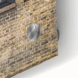 Large abstract wall art print in vibrant orange and blue tones on acrylic glass.