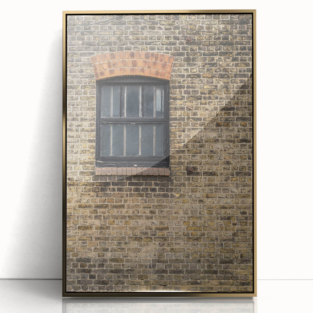 Framed acrylic print featuring a large, mid-century modernist abstract design in gold and black tones.